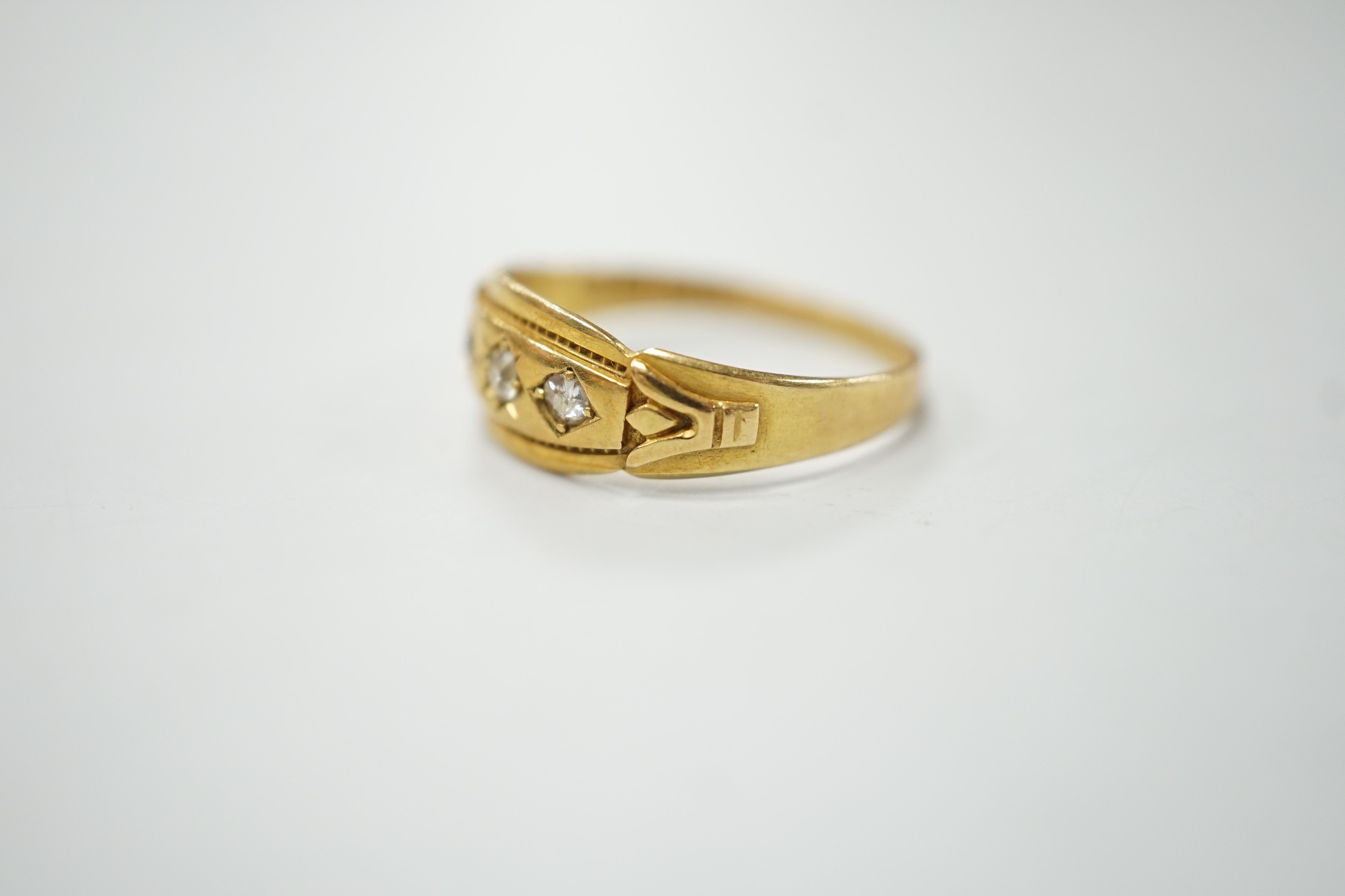 A late Victorian 18ct gold and gypsy set three stone diamond ring, size Q, gross weight 2.8 grams.